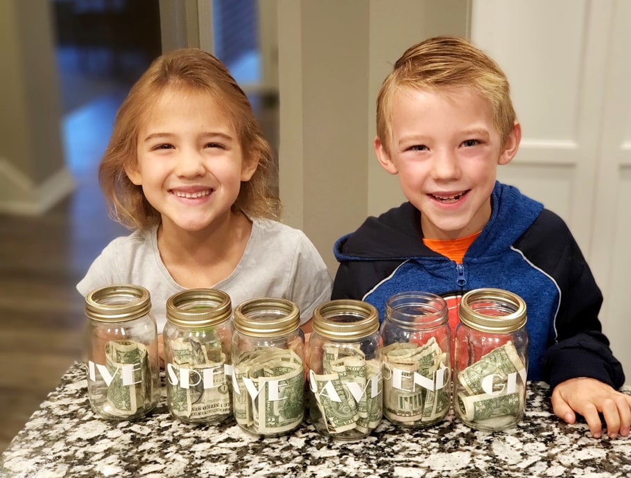 Bunney children with give, save, spend jars