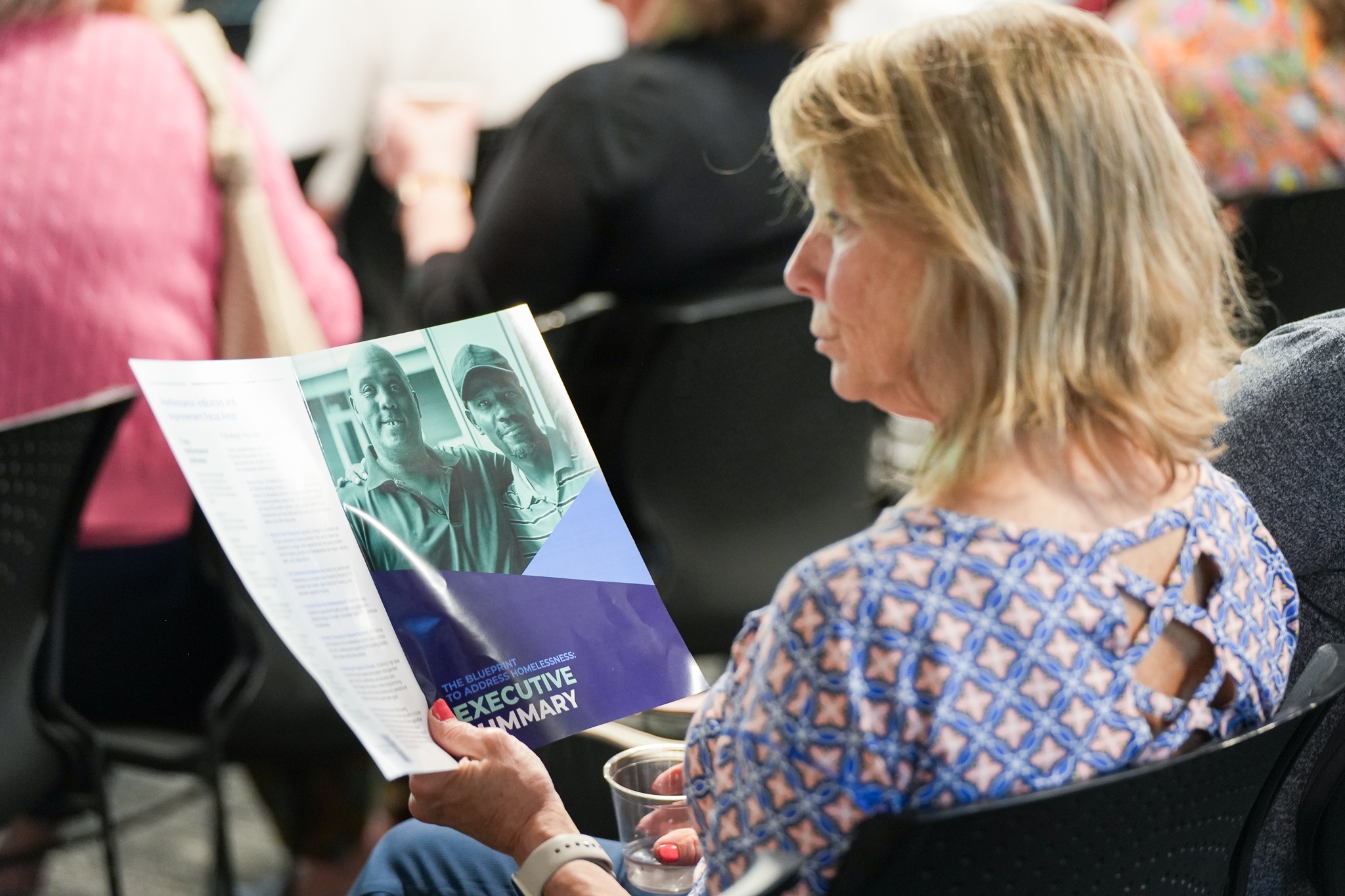 attendee reads Executive Summary of The Blueprint
